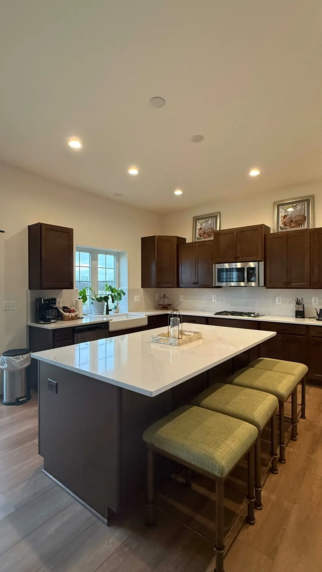 Finished open kitchen with quartz island and bar seating at the Nokesville guest retreat