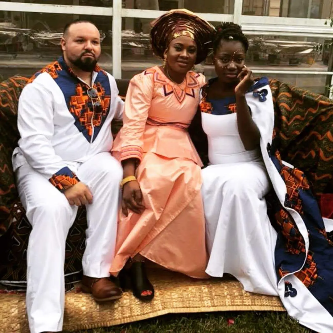 Family and guests celebrating in coordinated traditional attire